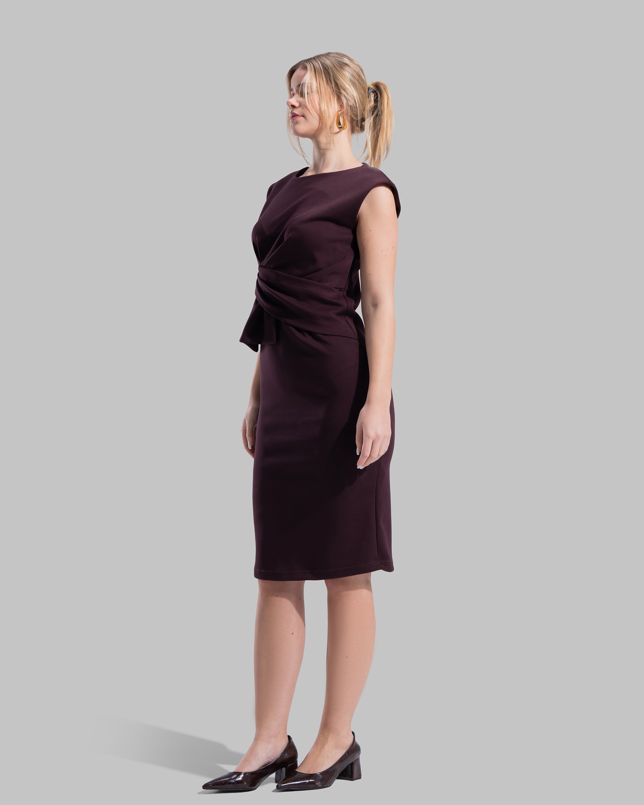Sleeveless midi dress featuring a round neckline and front draped knot detail.