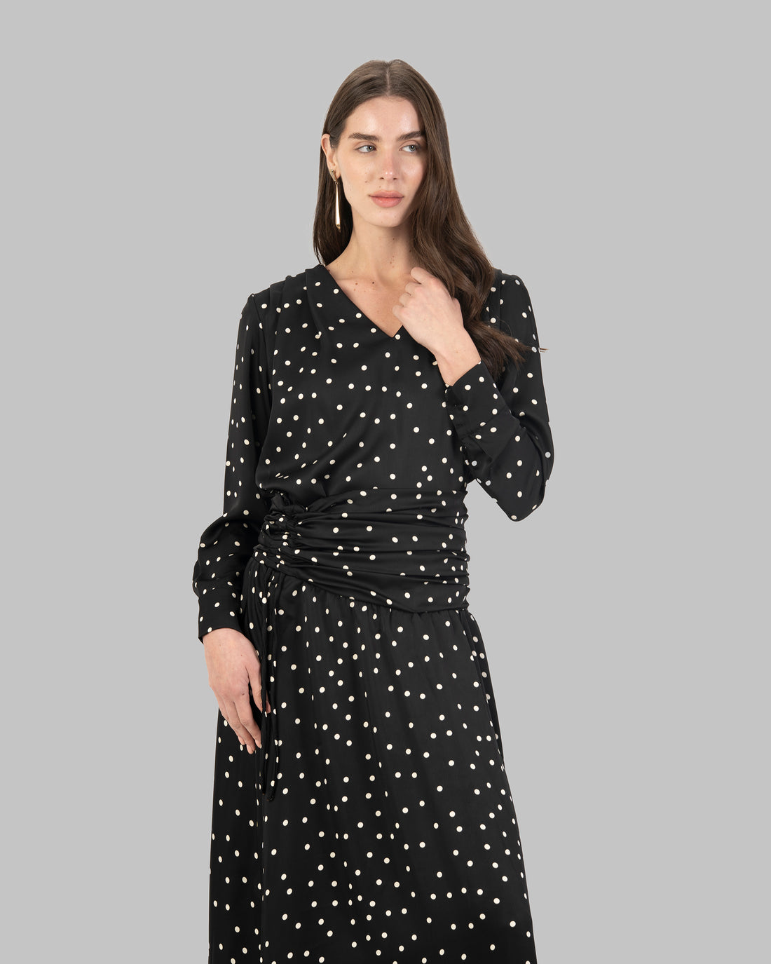 A sophisticated polka dots satin blouse with a clean V-neckline