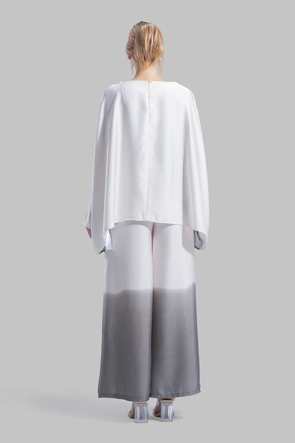 Draped asymmetrical blouse with a side-split design.