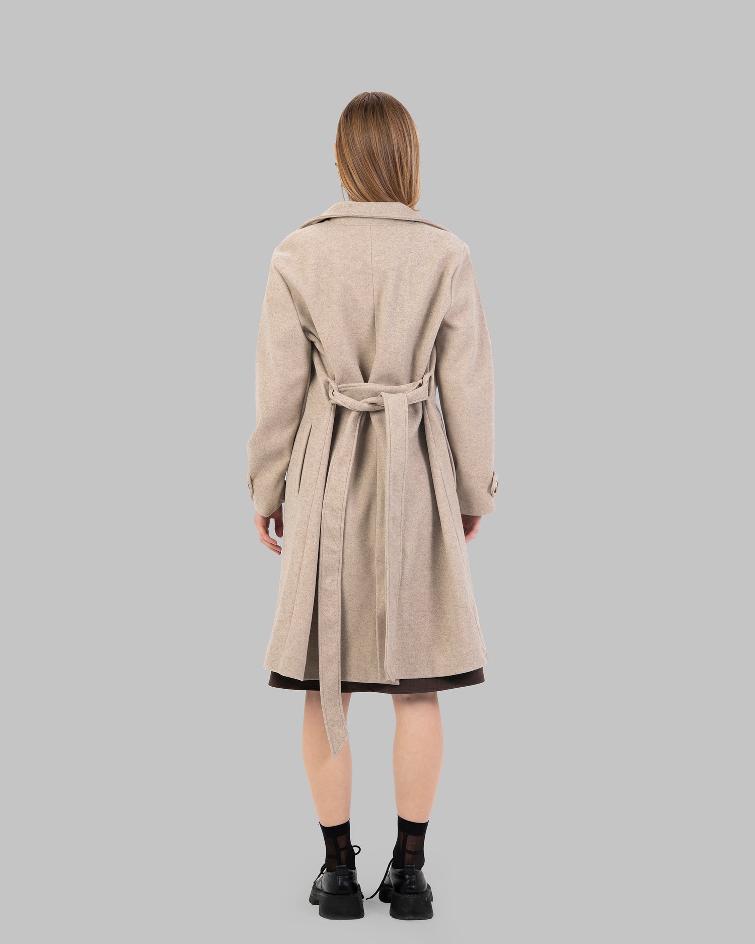 A classic light beige belted coat with a wide collar