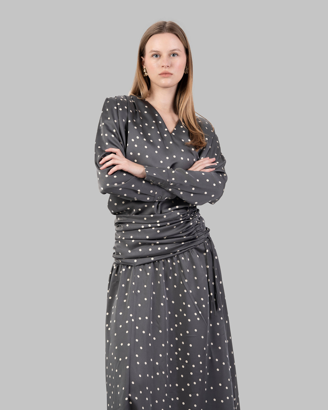 A sophisticated polka dots satin blouse with a clean V-neckline