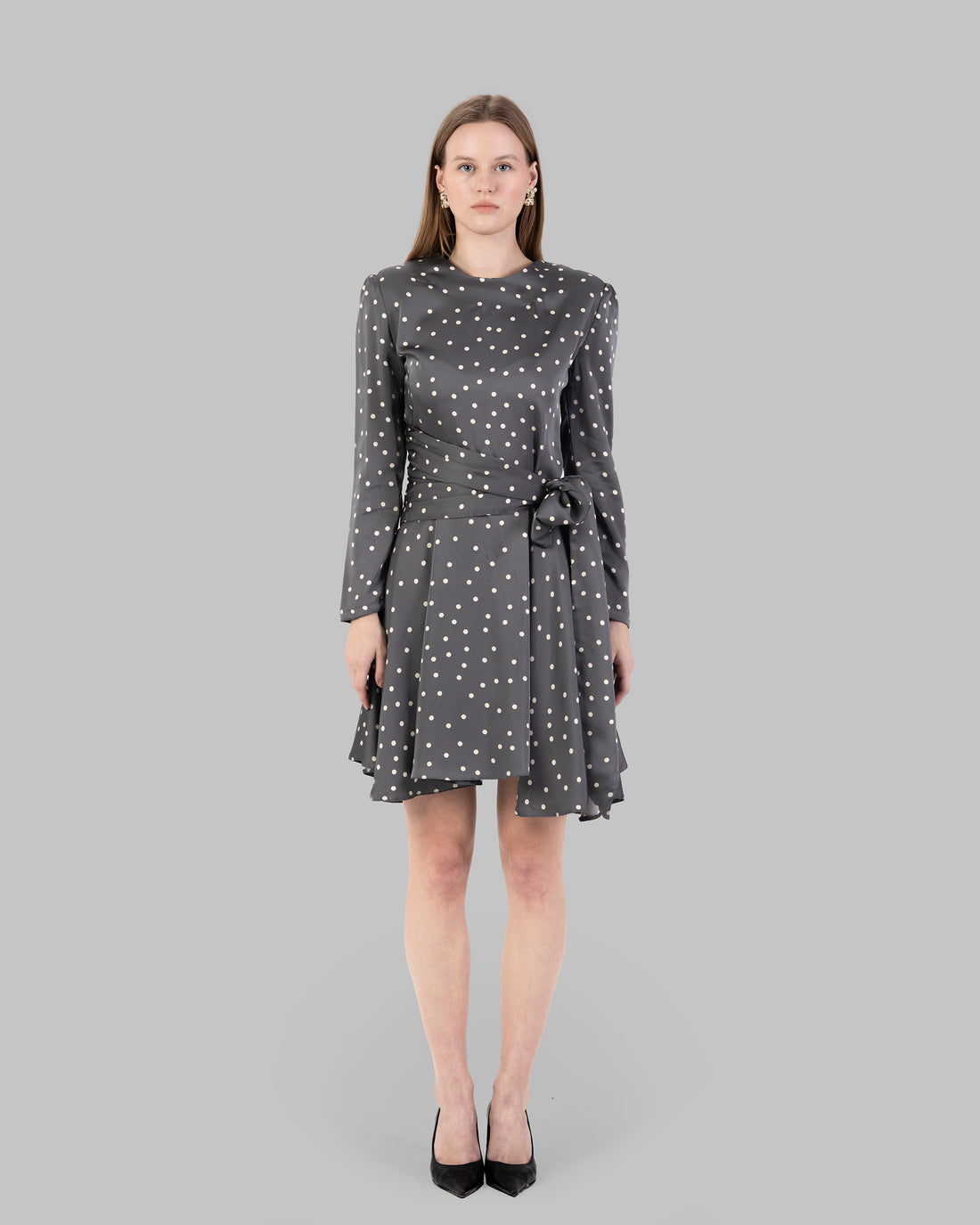 A chic polka dot mini dress with long sleeves and a stylish wrap-around tie waist