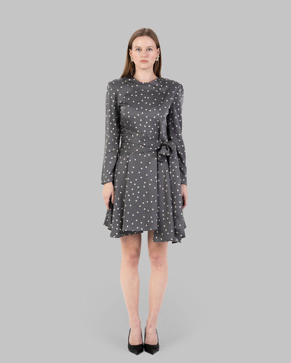A chic polka dot mini dress with long sleeves and a stylish wrap-around tie waist