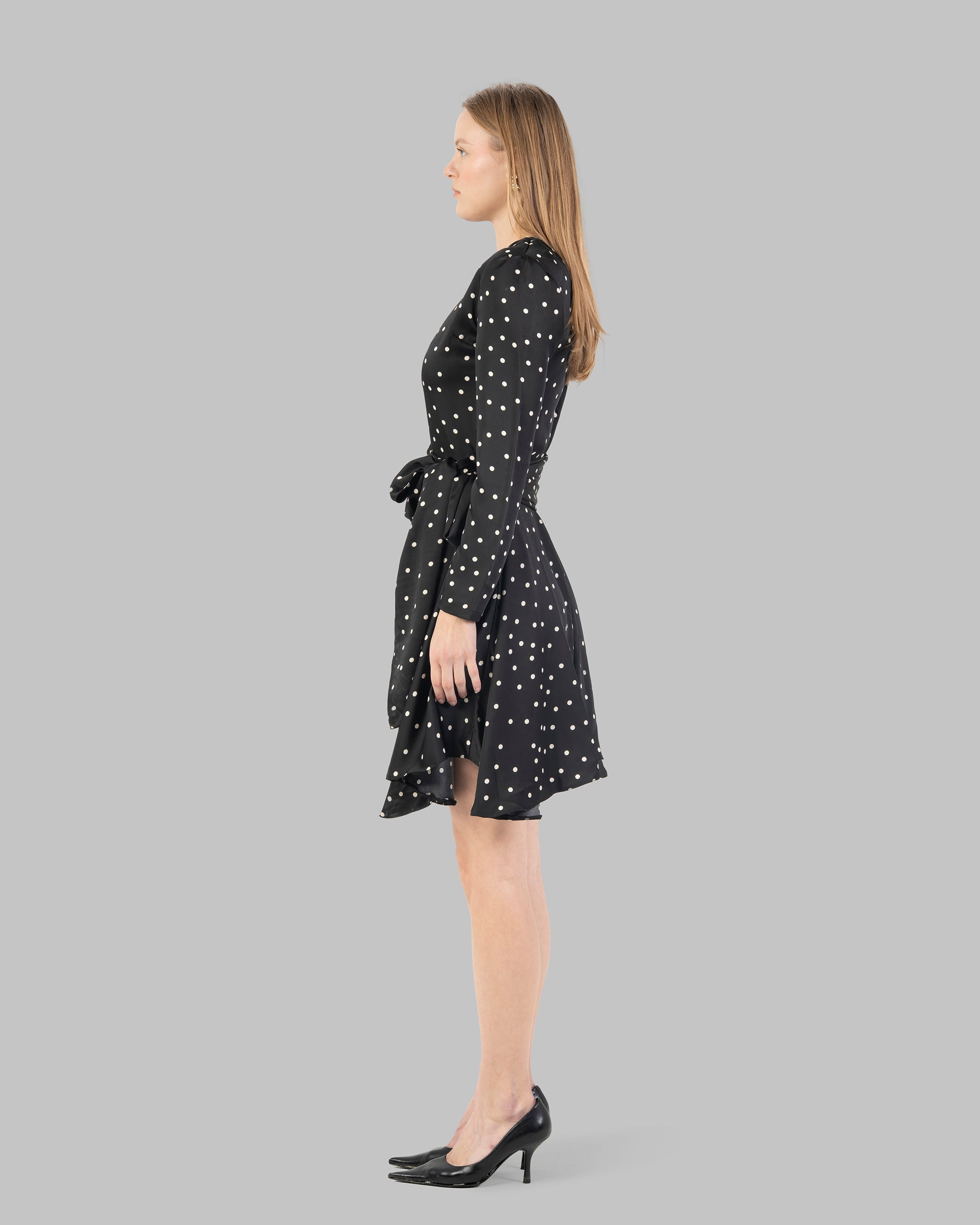 A chic polka dot mini dress with long sleeves and a stylish wrap-around tie waist