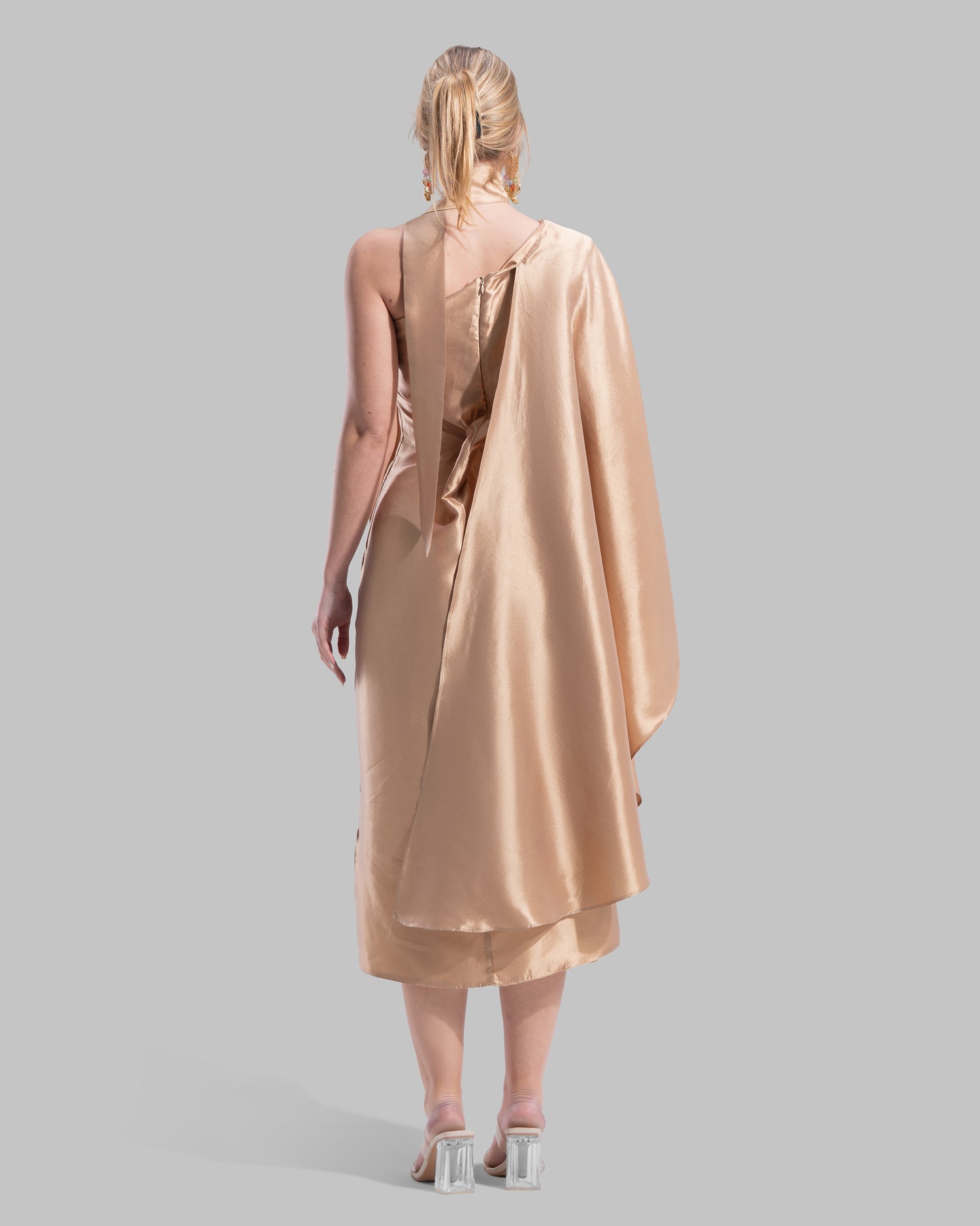 One-shoulder satin midi dress featuring a draped cape overlay and side slit
