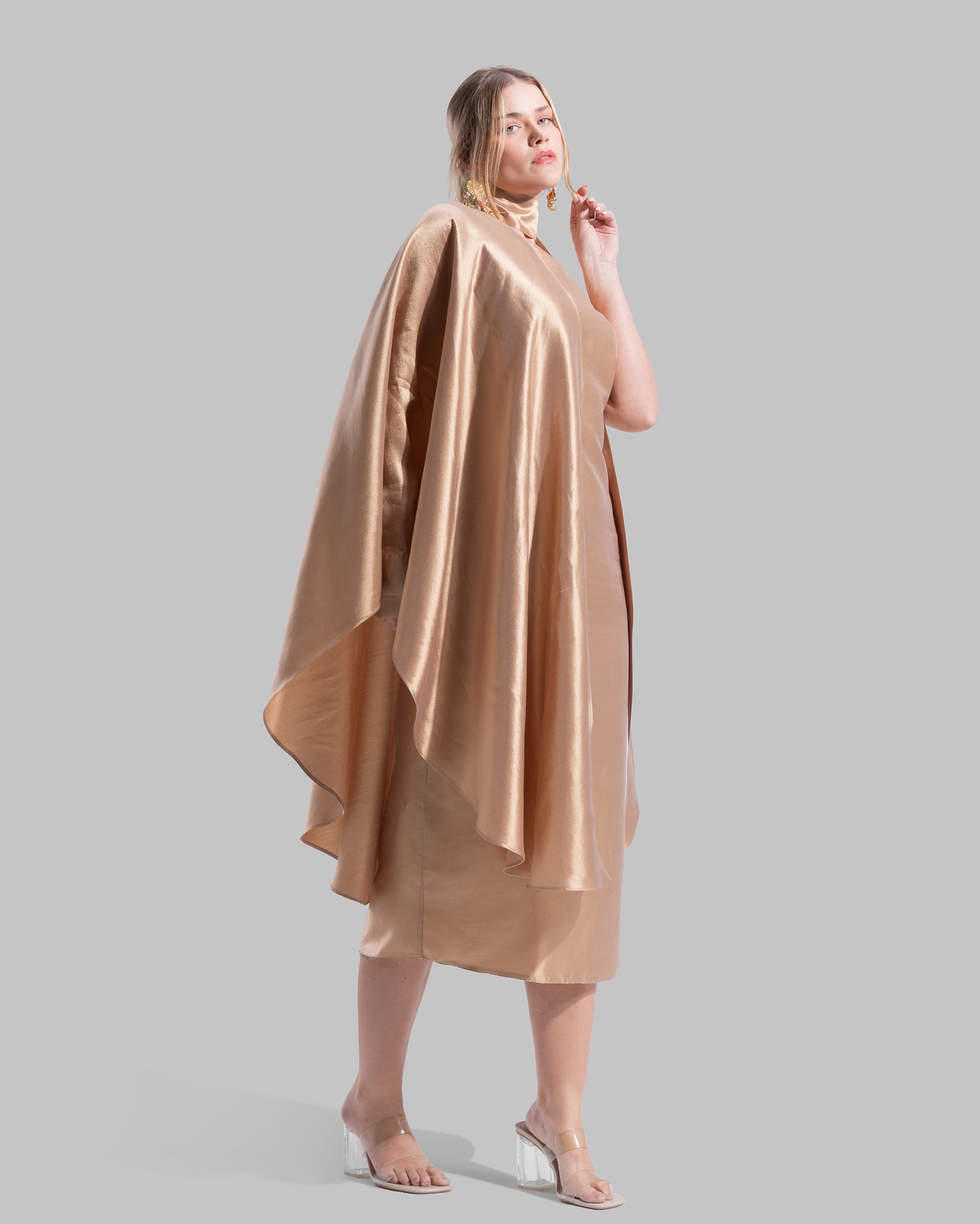 One-shoulder satin midi dress featuring a draped cape overlay and side slit