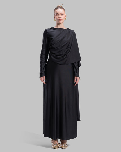 Long draped dress with a round neckline and asymmetrical overlay detail.