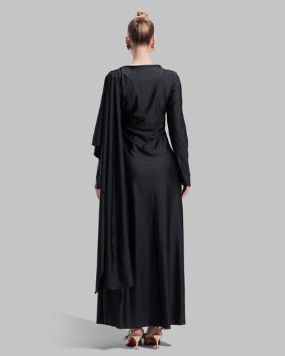 Long draped dress with a round neckline and asymmetrical overlay detail.