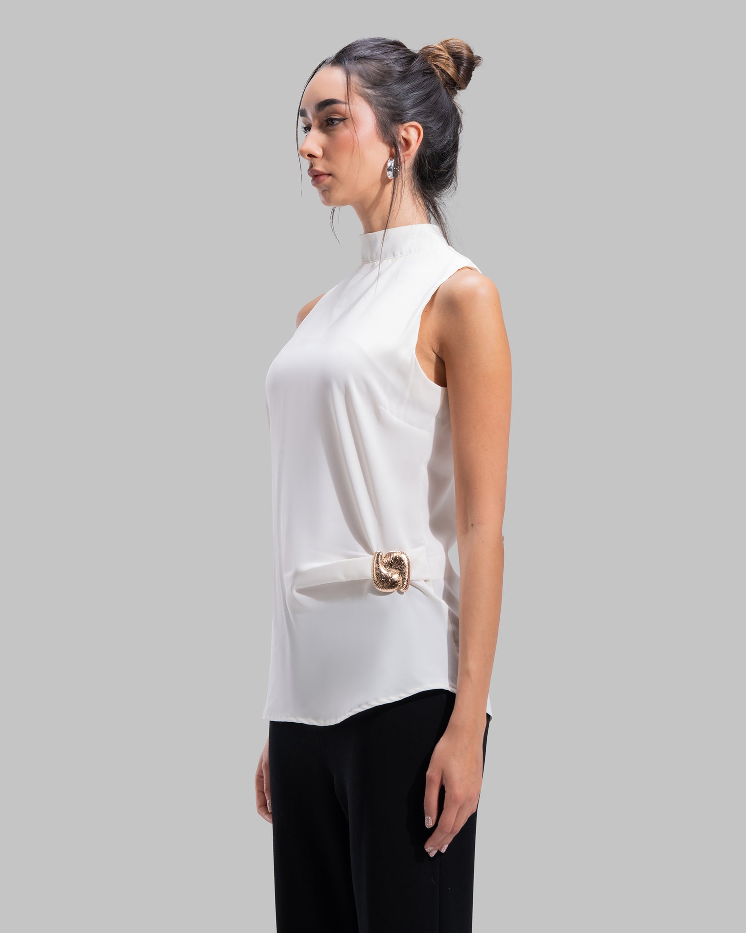 Sleeveless high-neck top with gathered detail and a metallic side buckle.