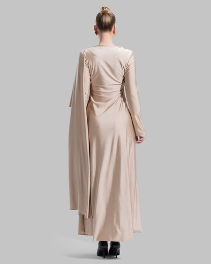 Long draped dress with a round neckline and asymmetrical overlay detail.
