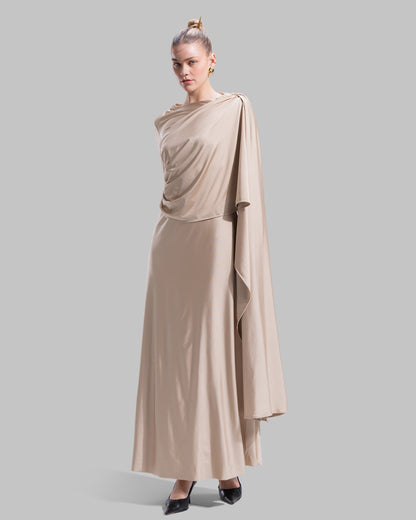 Long draped dress with a round neckline and asymmetrical overlay detail.