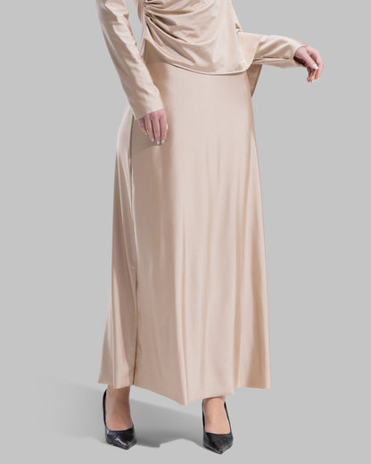 Long draped dress with a round neckline and asymmetrical overlay detail.
